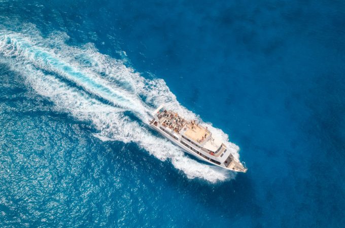 aerial-view-of-beautiful-floating-yacht-in-blue-se-2023-11-27-05-25-34-utc